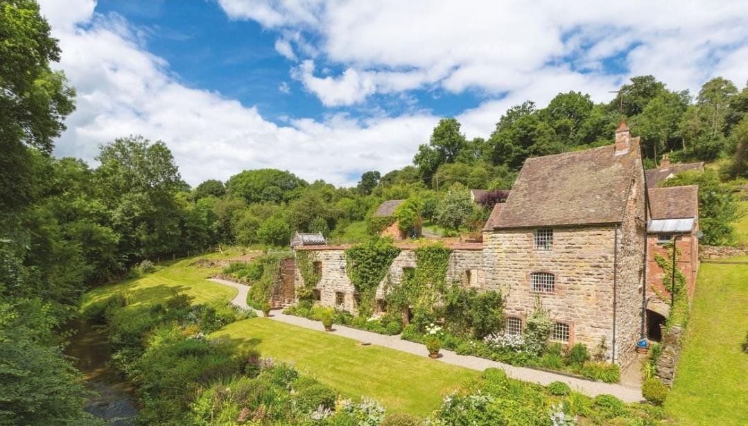 A traditional stone country home seen from the garden